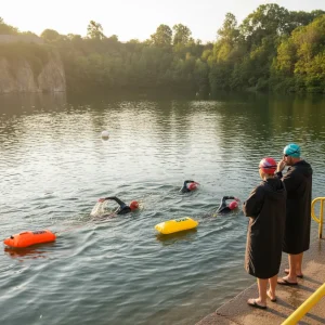 open water swimmers in Dosthill Quarry towing swim floats